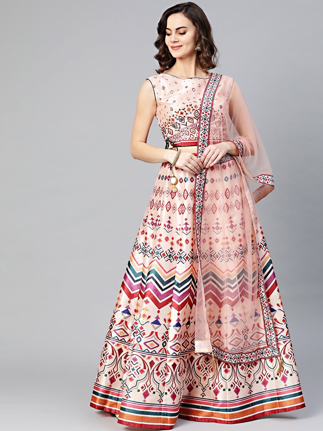 

Chhabra 555 Women Peach Crop Top Lehenga Set with Mirror work & Abstract Tribal print