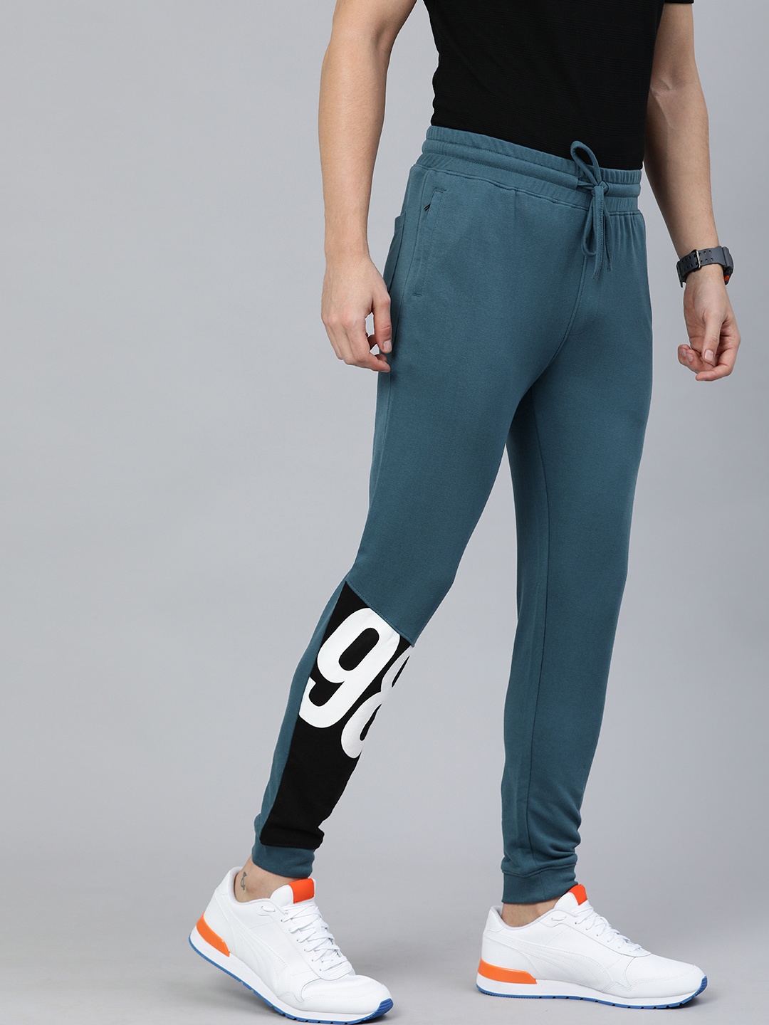 

The Indian Garage Co Men Teal Blue Solid Regular Fit Joggers with Print Detail