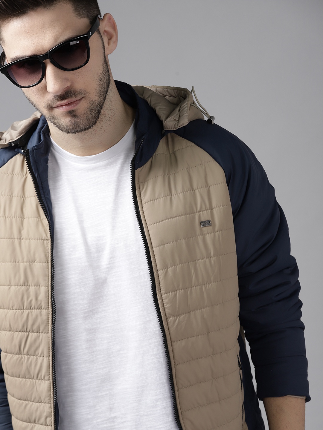 

Roadster Men Beige & Navy Blue Solid Detachable Hood Padded Jacket