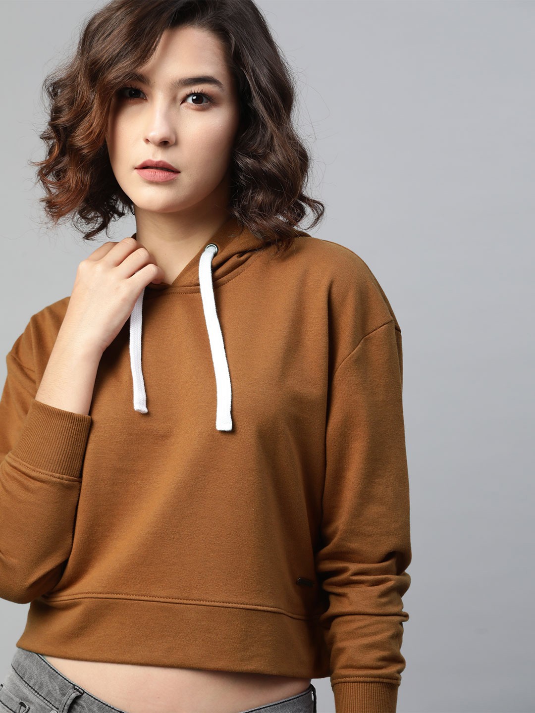 

Roadster Women Mustard Brown Solid Cropped Hooded Sweatshirt