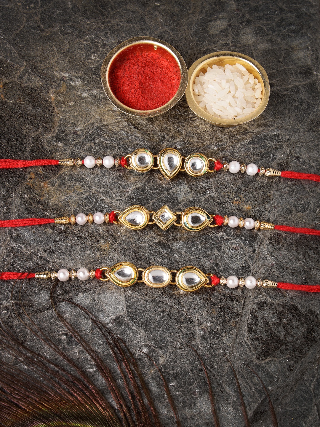 

Sukkhi Rakhi Men Set Of 3 Gold-Toned Red & White Stone-Studded & Beaded Rakhi With Roli Chawal & Greeting Card