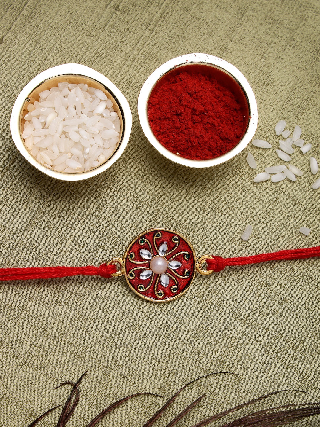 

Sukkhi Rakhi Men Gold Plated & Red Rakhi With Roli Chawal And Raksha Bandhan Greeting Card