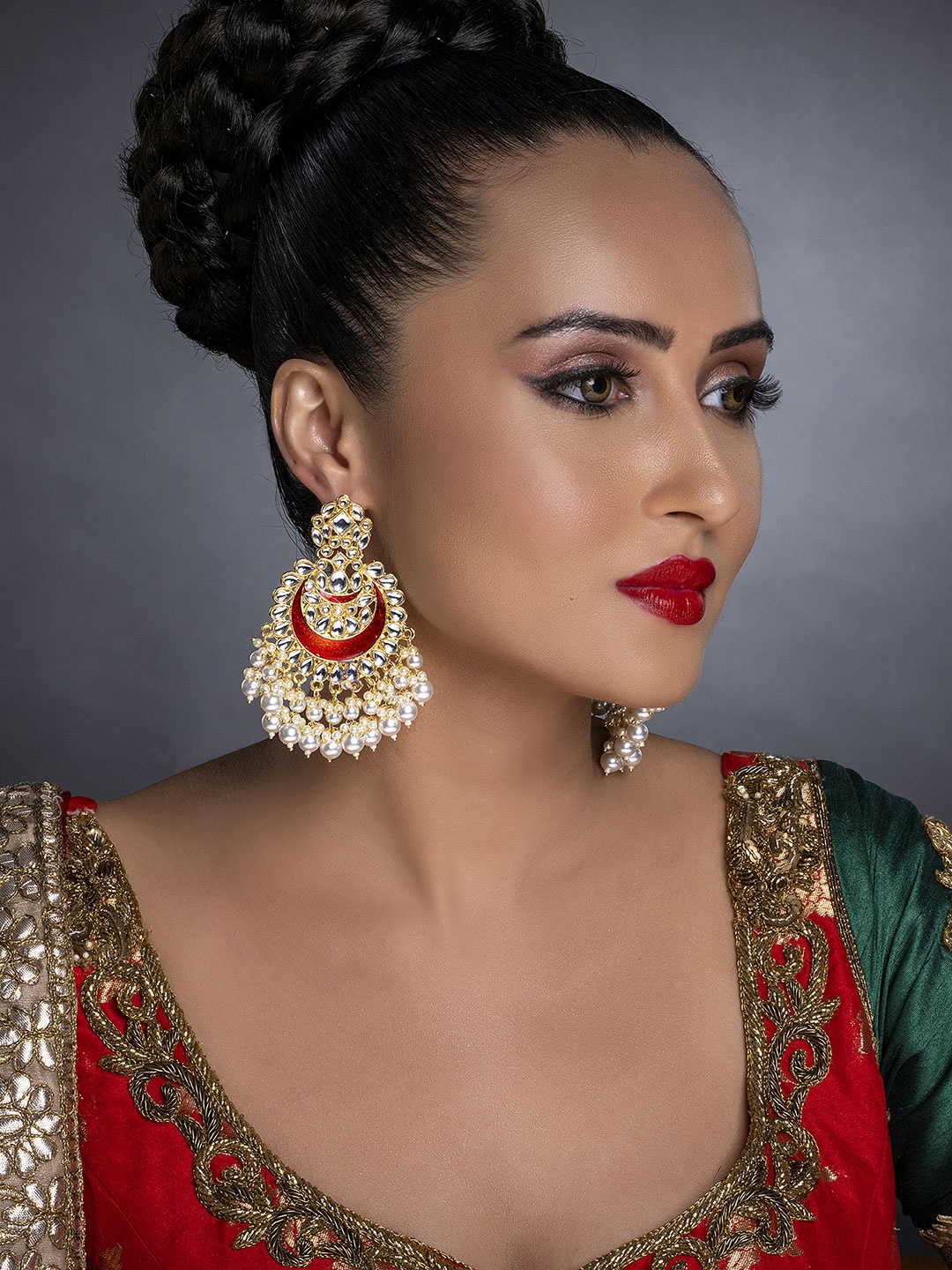 

Sukkhi Maroon Gold-Plated Kundan Studded Handcrafted Crescent Shaped Chandbalis