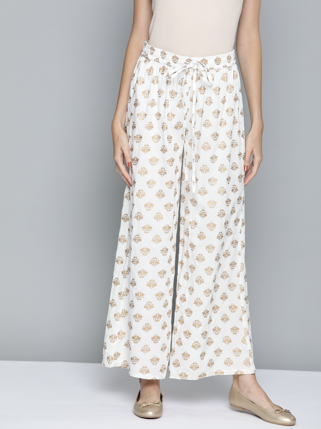 

HERE&NOW Women White & Golden Ethnic Motifs Printed Palazzos