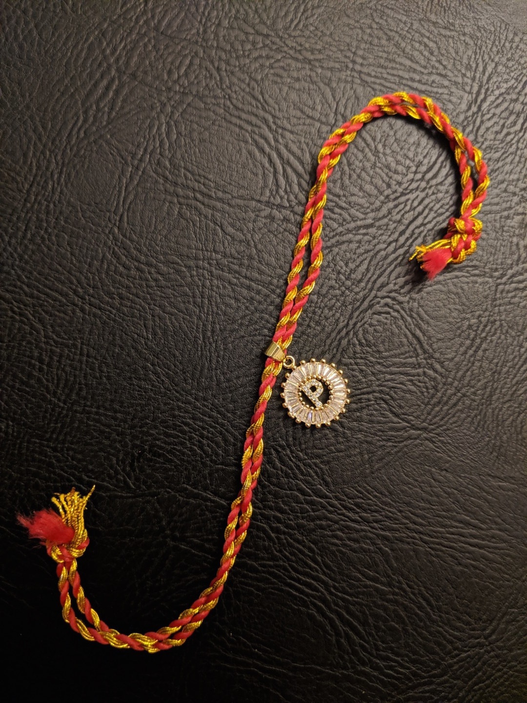 

Digital Dress Room Letter P Gold-Plated Customised AD Pendant Mauli Rakhi