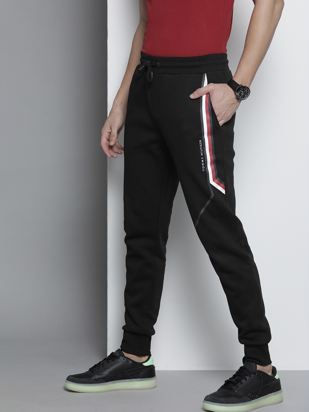 

Tommy Hilfiger Men Black Solid Joggers with Logo Print
