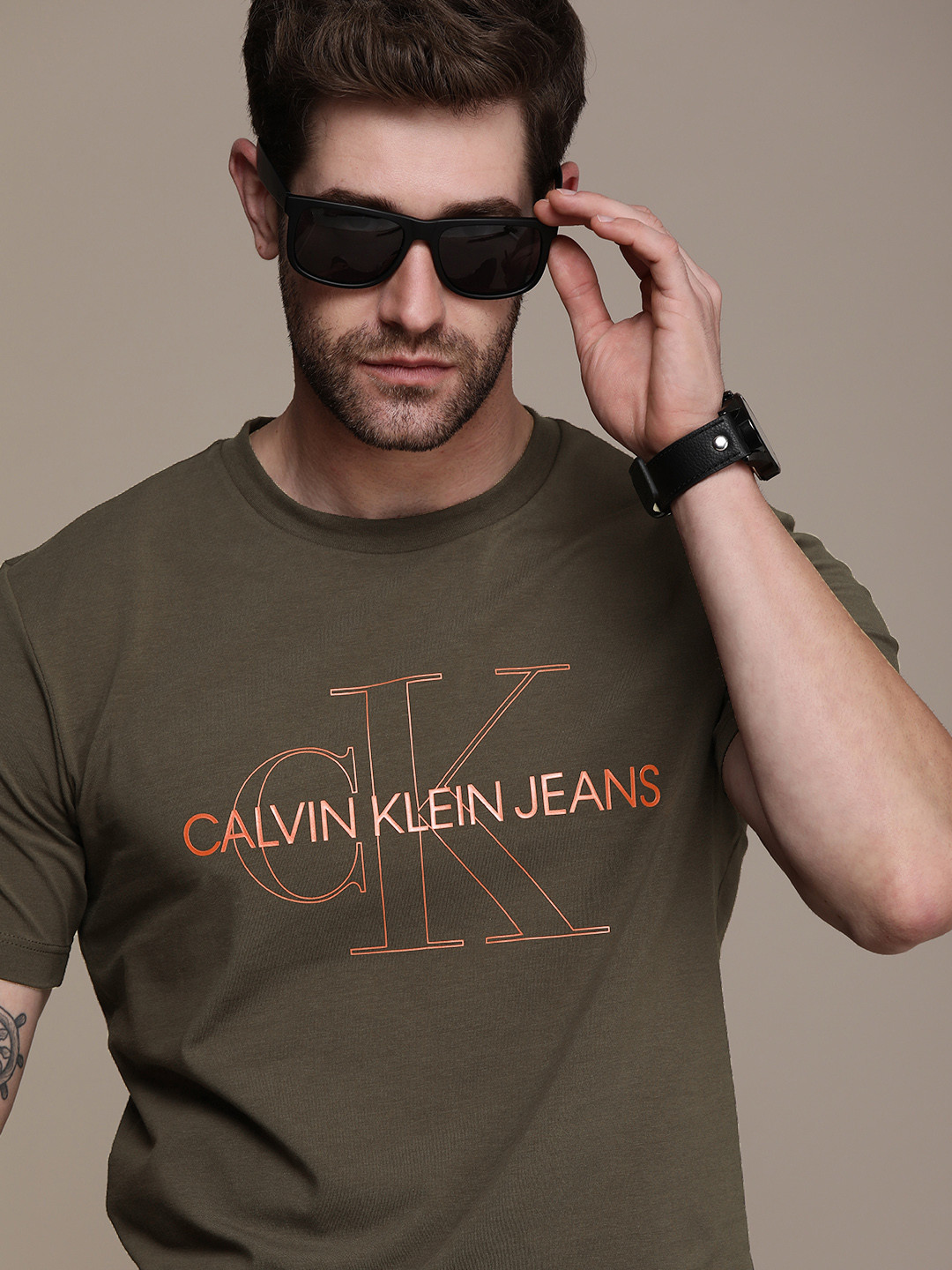 

Calvin Klein Jeans Men Olive Green Brand Logo Printed Slim Fit T-shirt