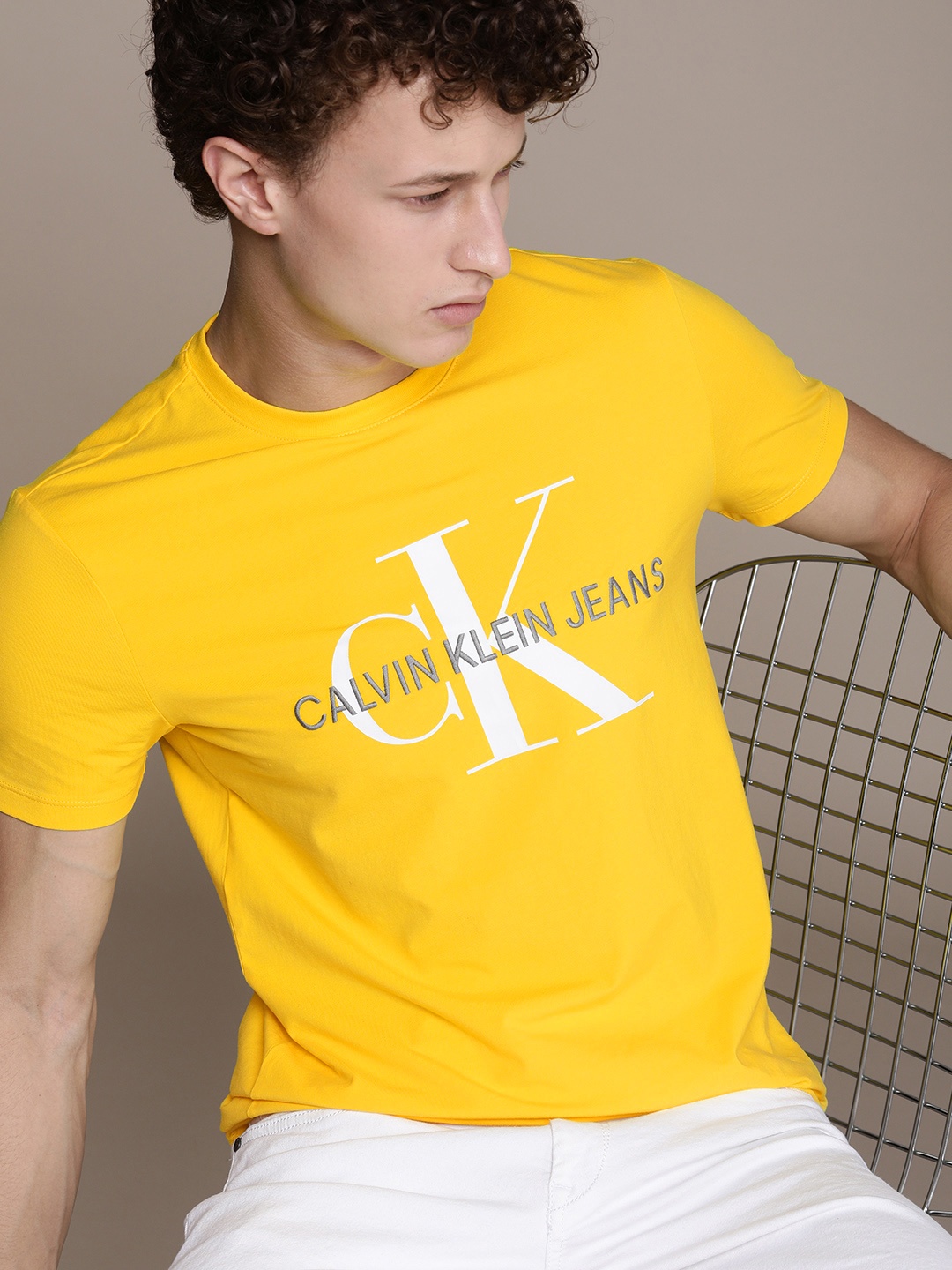

Calvin Klein Jeans Men Yellow & White Printed T-shirt