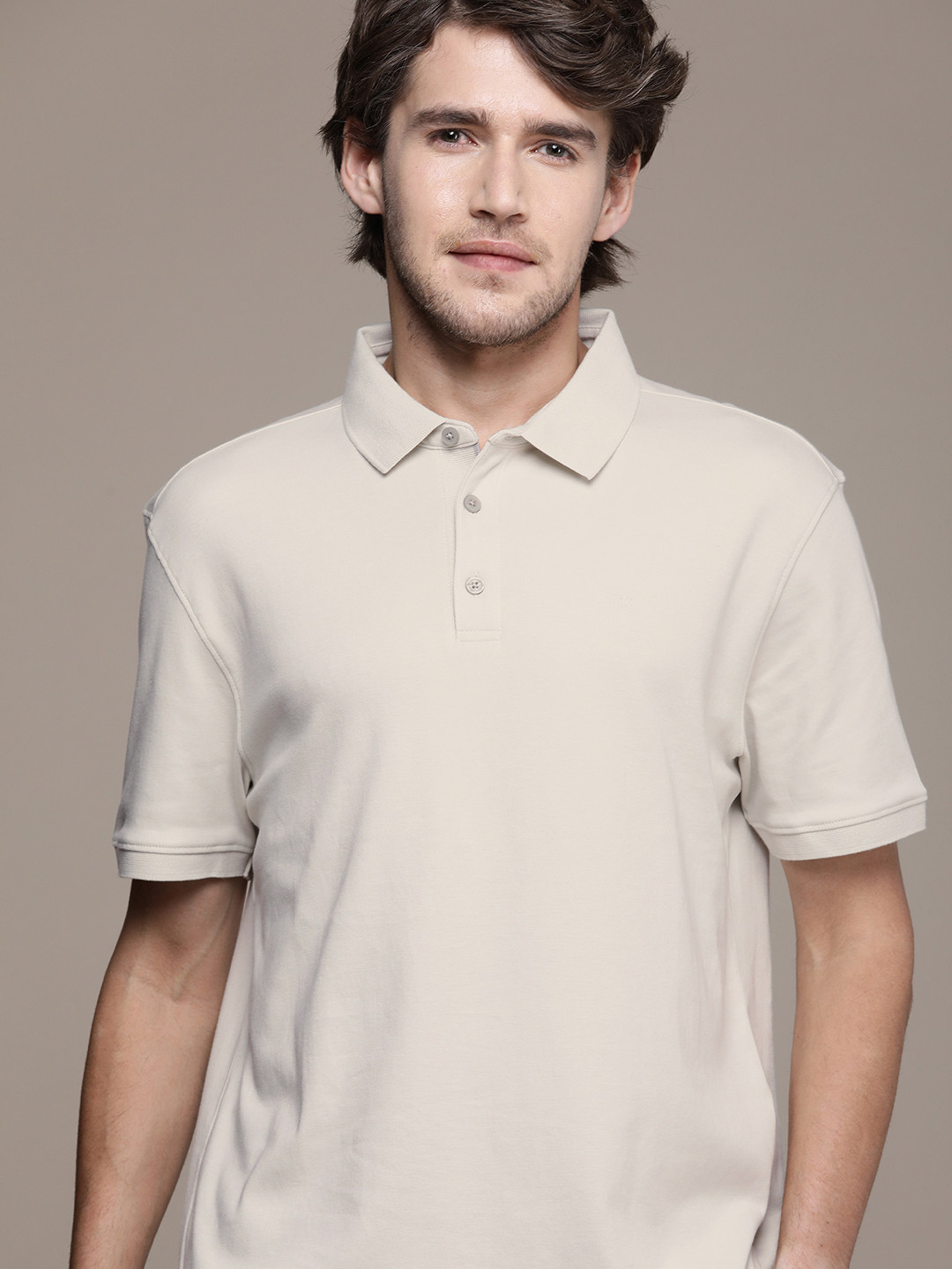 

Calvin Klein Jeans Men Off White Solid Polo Collar Pure Cotton T-shirt