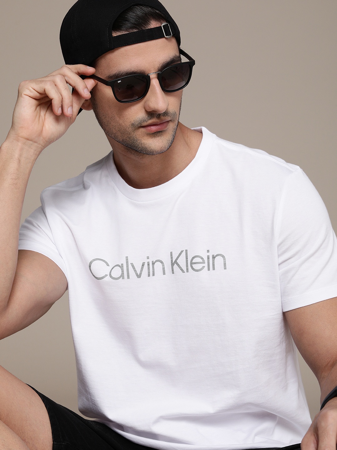 

Calvin Klein Jeans Men White Solid Pure Cotton T-shirt With Grey Typography Front