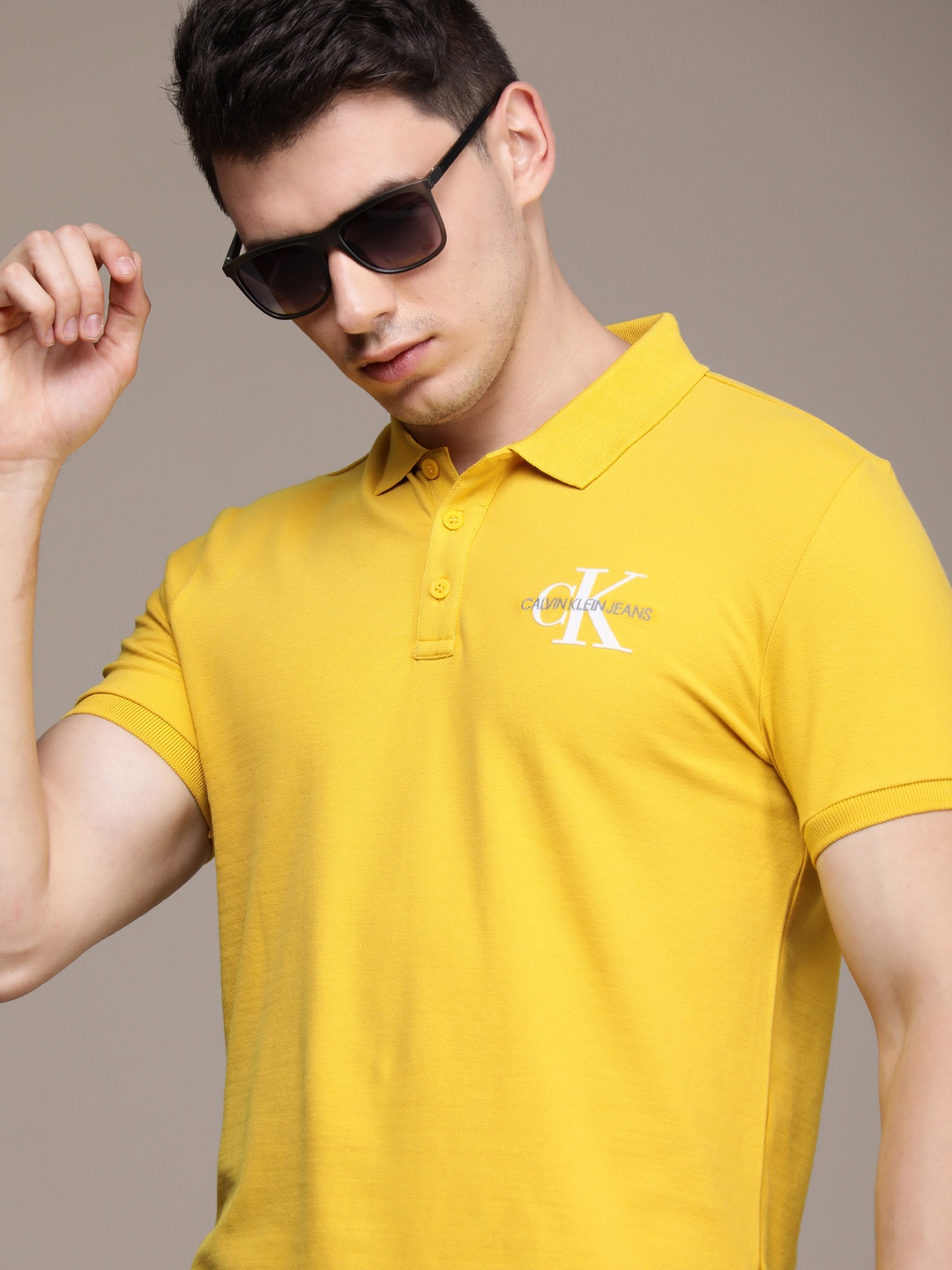 

Calvin Klein Jeans Men Yellow & White Brand Logo Embroidered Polo Collar Slim Fit T-shirt