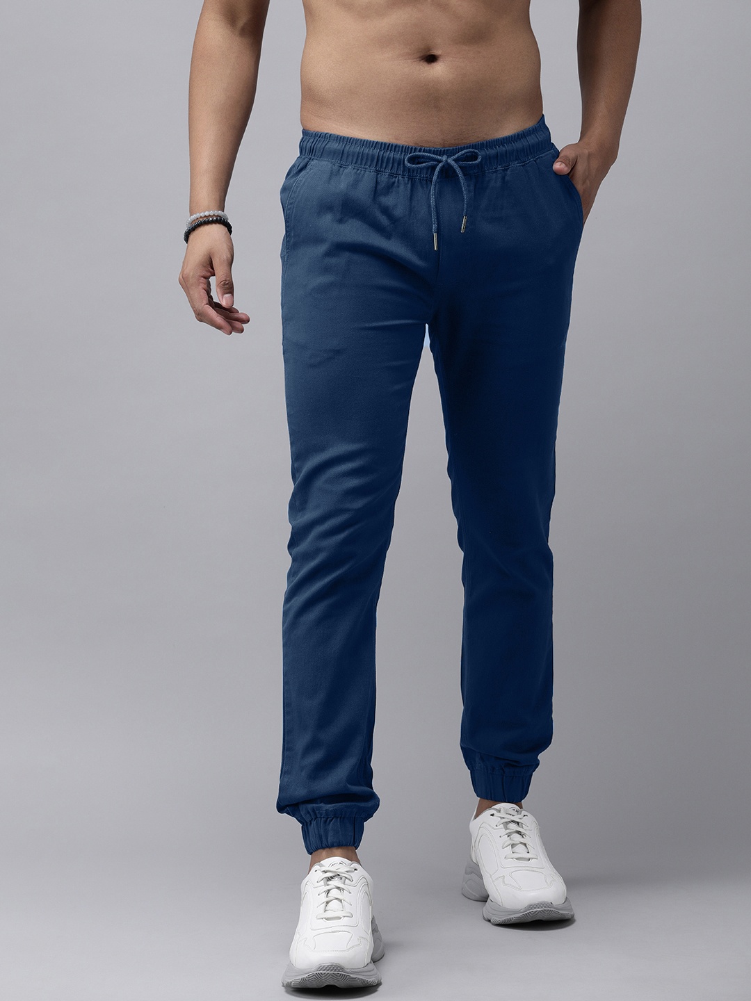 

Roadster Men Teal Blue Solid Regular Fit Mid Rise Joggers Trousers