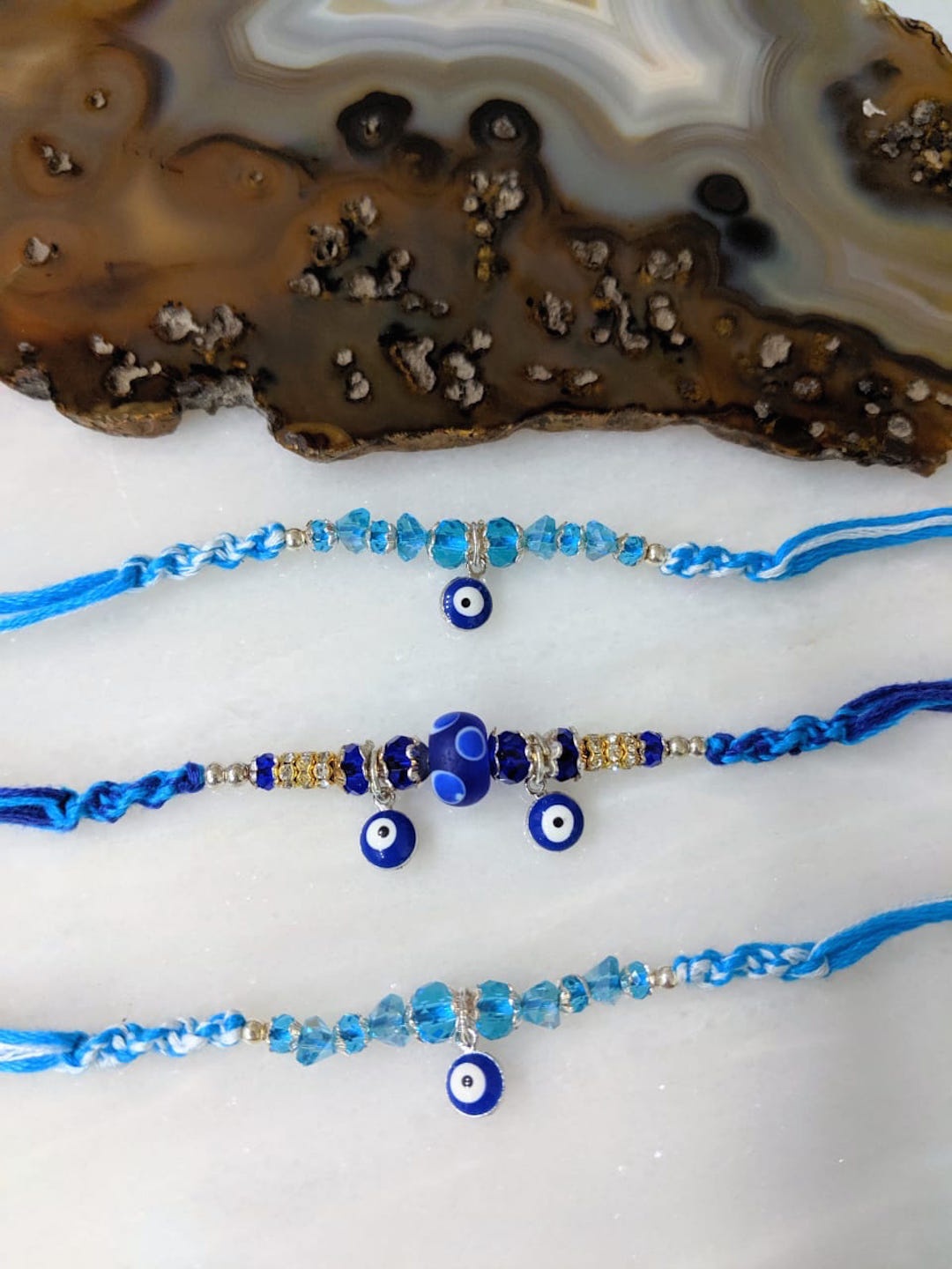 

Digital Dress Room Set of 3 Blue Evil Eye Rakhis with Flower Turkish Charm, White