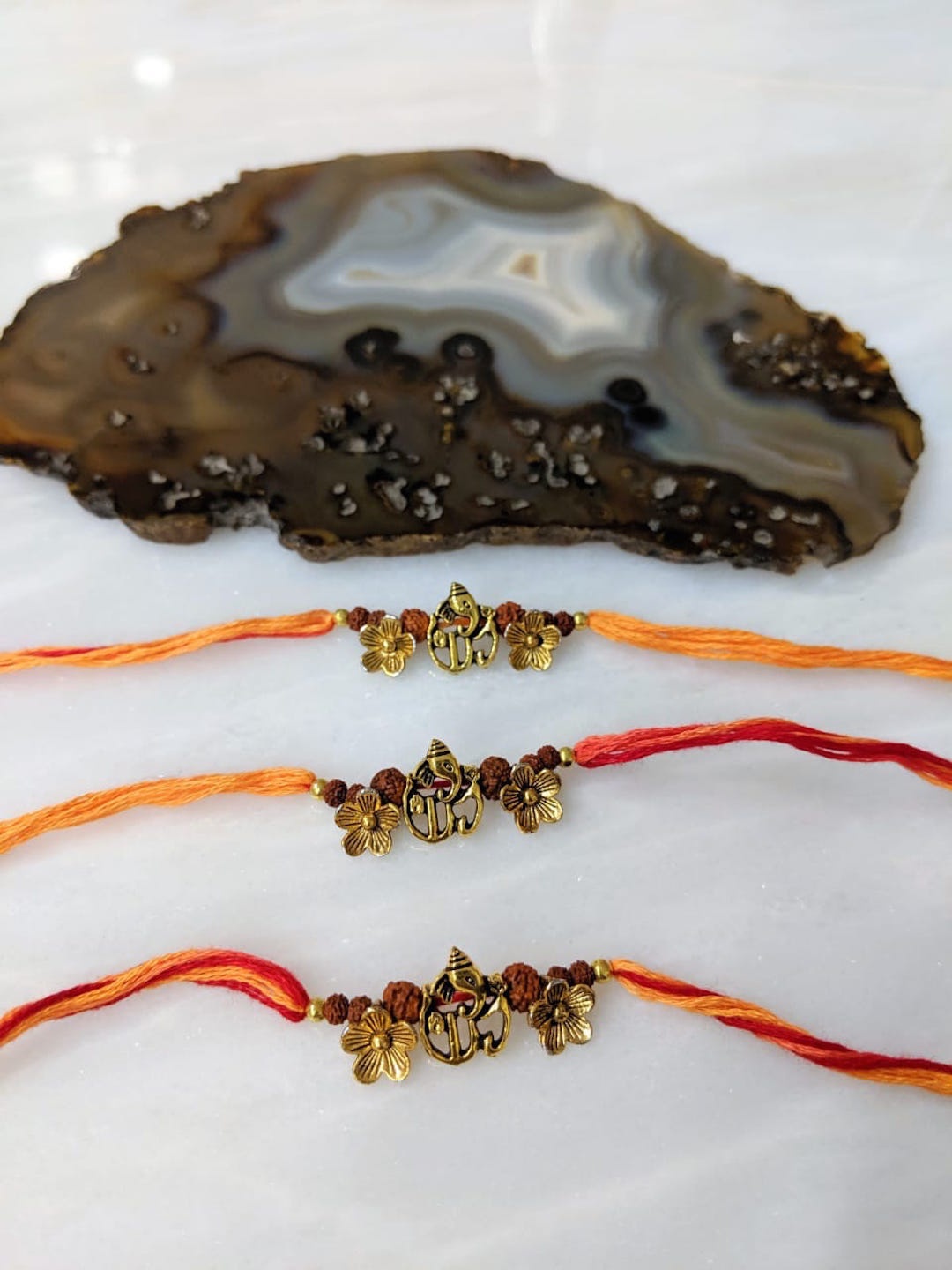 

Digital Dress Room Pack Of 3 Ganesh Ji Pendant with Flower Mauli Rakshis, Red