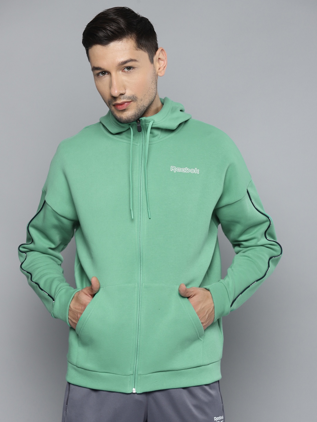 

Reebok Men Green TE Piping FZ Solid Training Hoodie