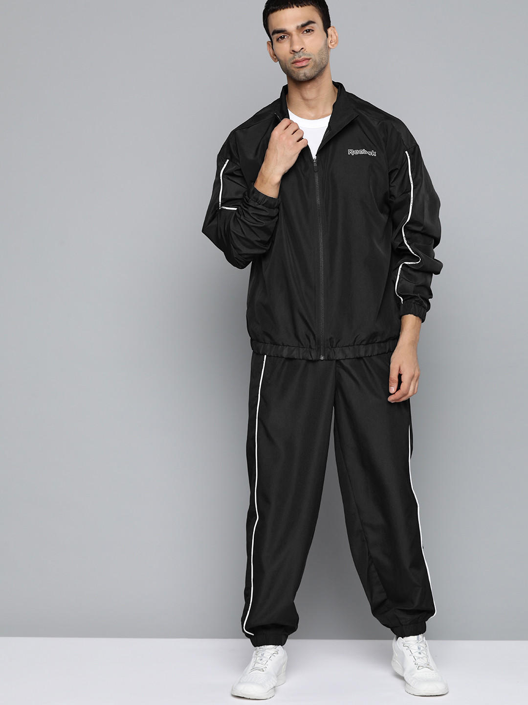 

Reebok Men Black Solid TE PIPING TRACKSUIT