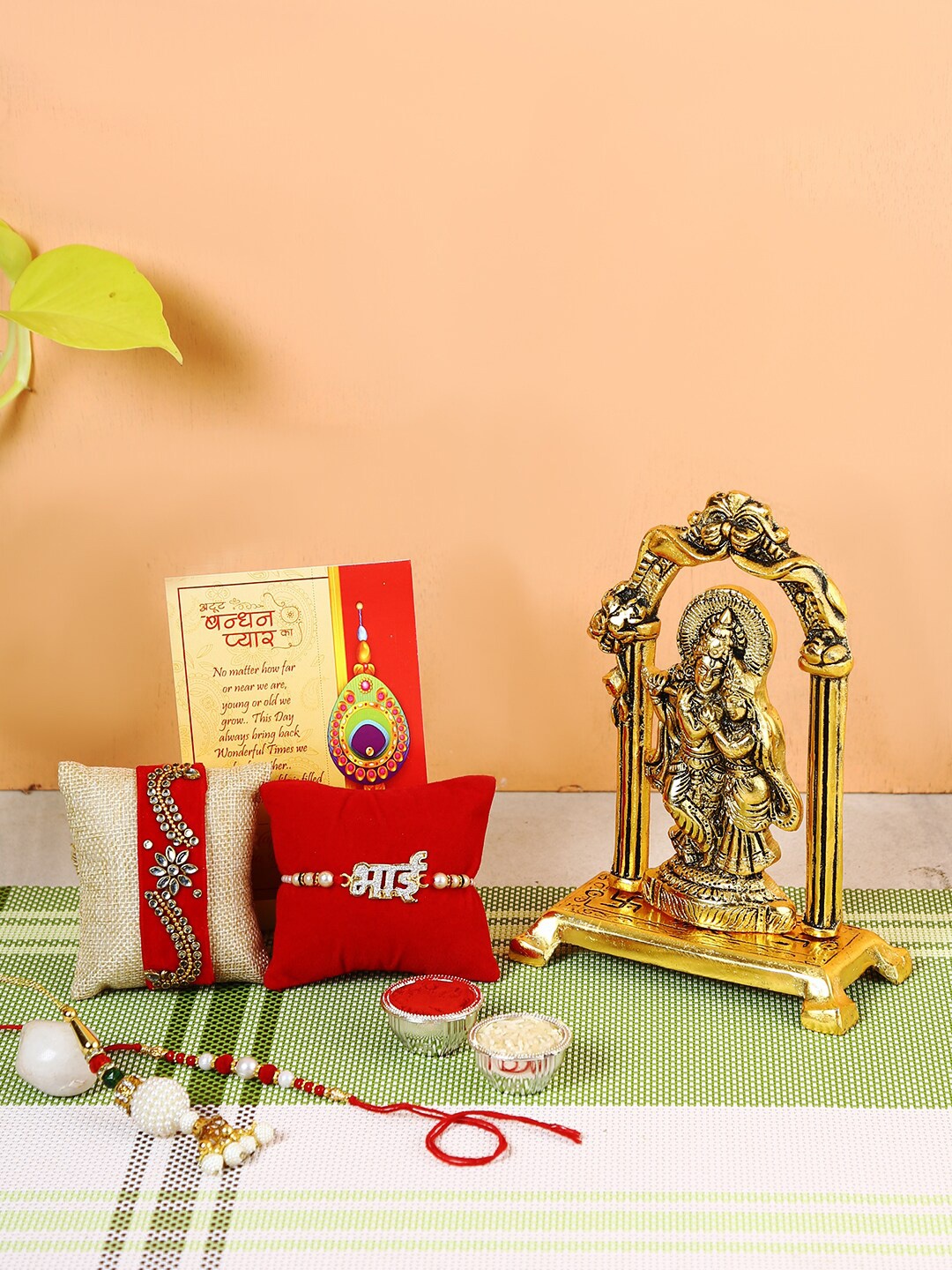 

CraftVatika Set Of 4 Rakhi With Gold-Plated Radha Krishna Idol, Red