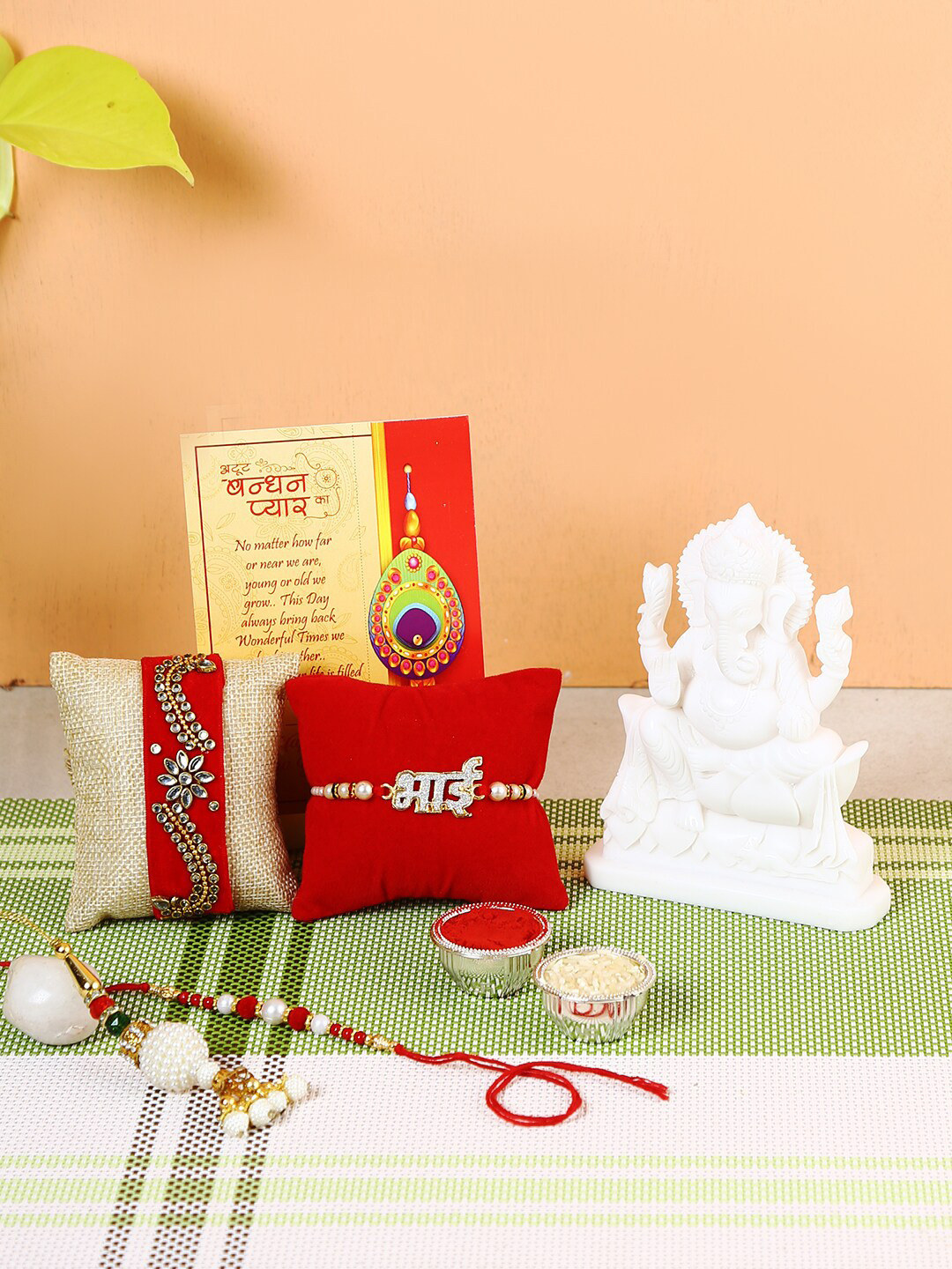 

CraftVatika Set Of 4 Rakhi With Marble Ganesha Idol, Red