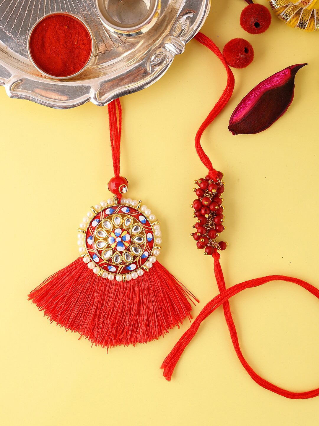 

Voylla Unisex Designer Bhaiya Bhabhi Rakhi Set with Roli Chaawal Pack, Red