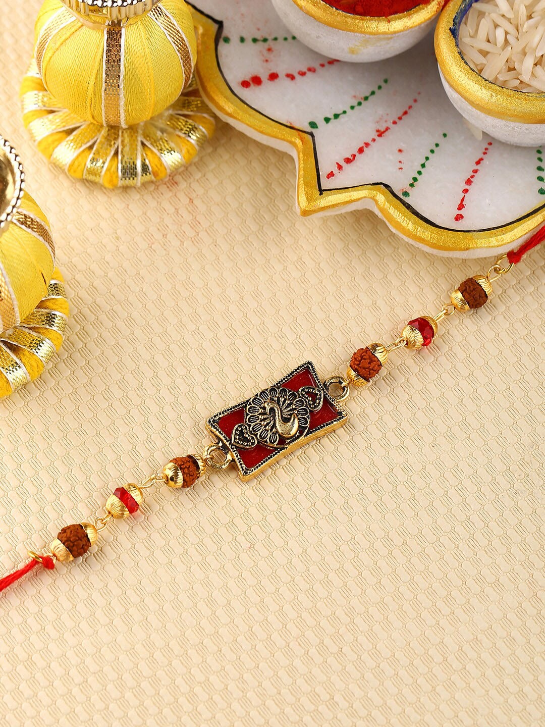 

Voylla Unisex Dancing Peacock Antique Rakhi with Roli Chawal, Gold