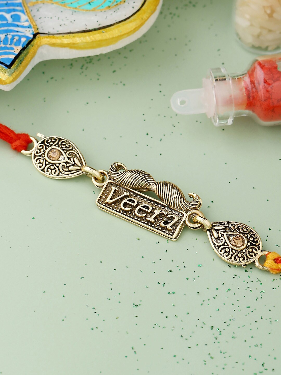 

Voylla Antique Designer Veera Rakhi with Roli Chaawal Pack, Red