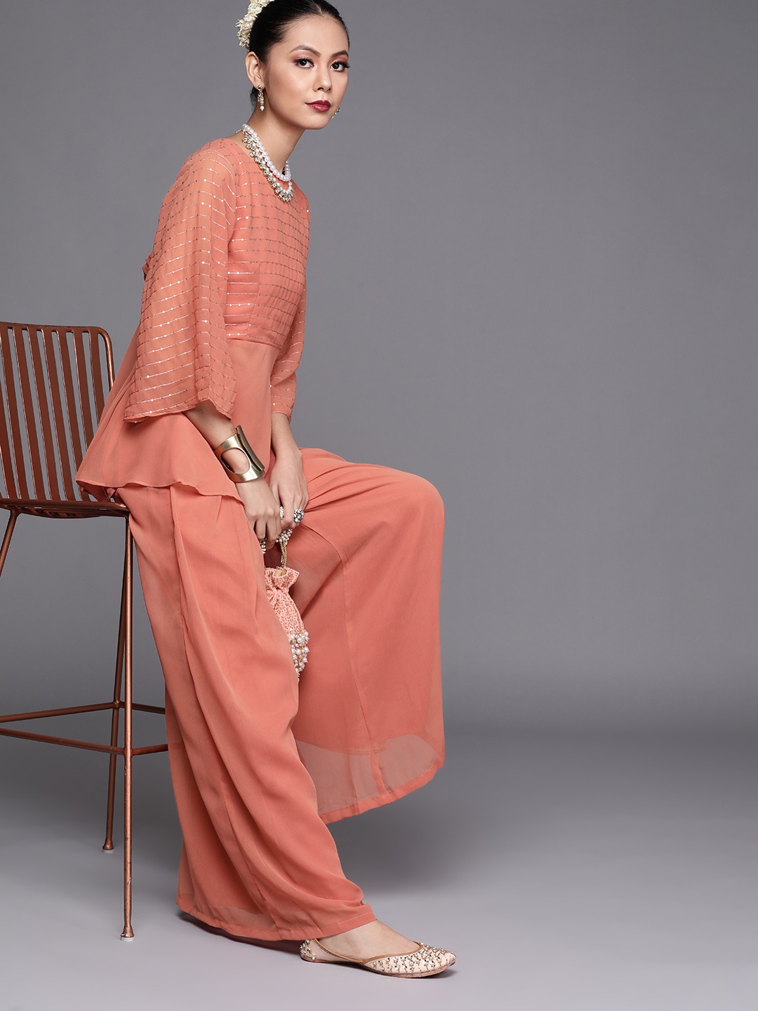 

Inddus Women Coral Orange Sequinned Kurti with Palazzos