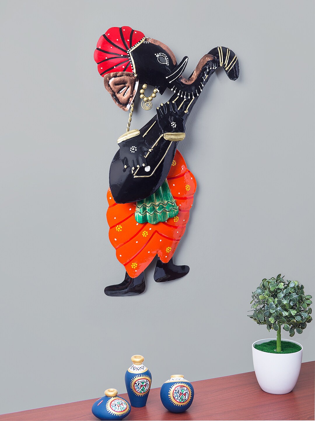

Golden Peacock Orange & Black Lord Ganesha Playing Sitar Wall Hanging Decor