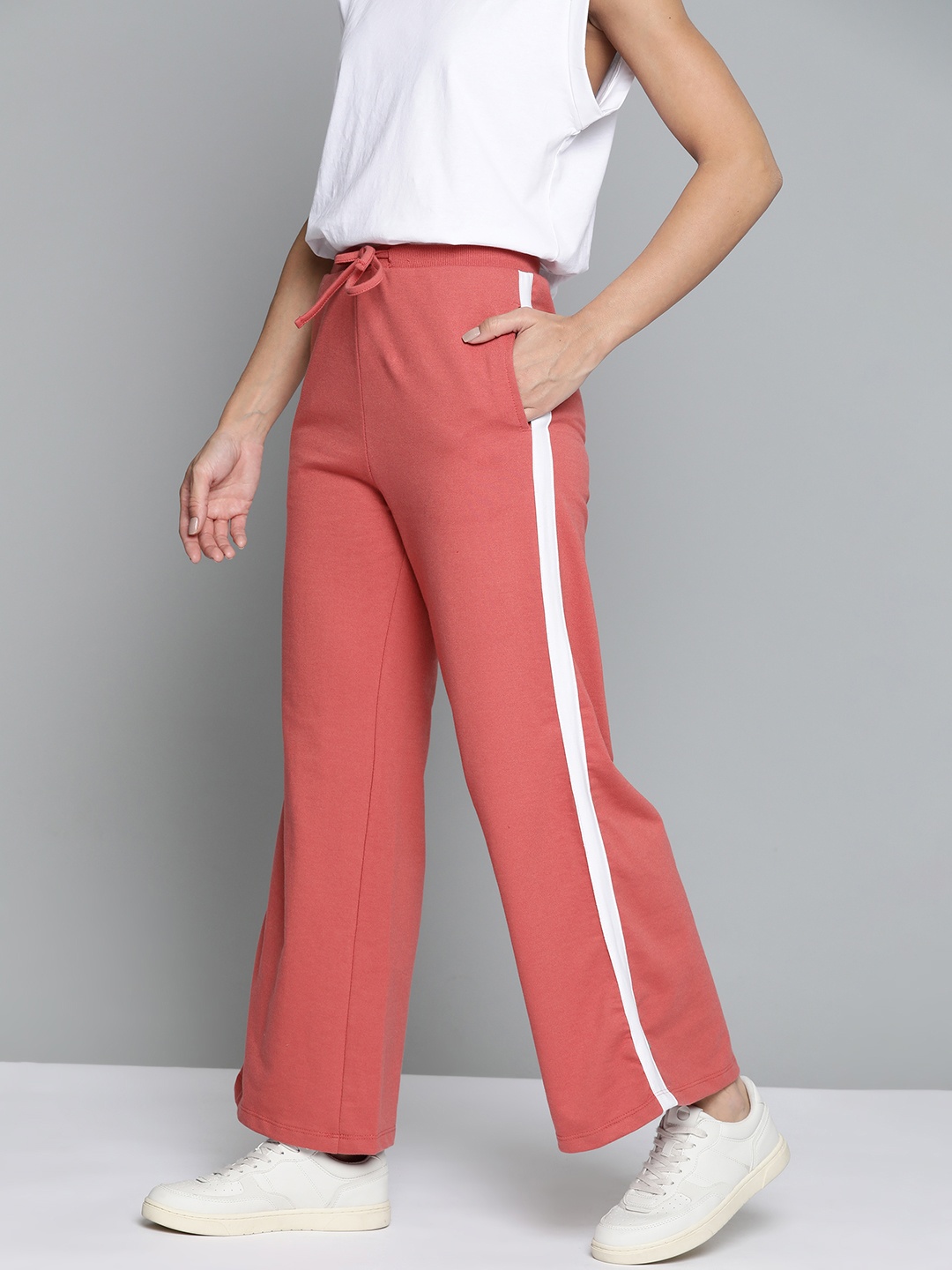 

Mast & Harbour Women Coral Pink Solid Flared Track Pants with Contrast Side Panelling