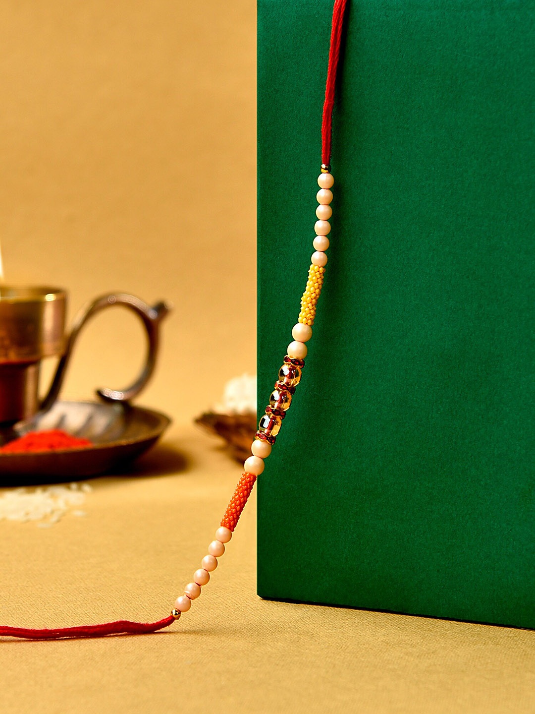 

Zaveri Pearls Multicolor Beads Embellished Rakhi With Chawal Roli, Multi