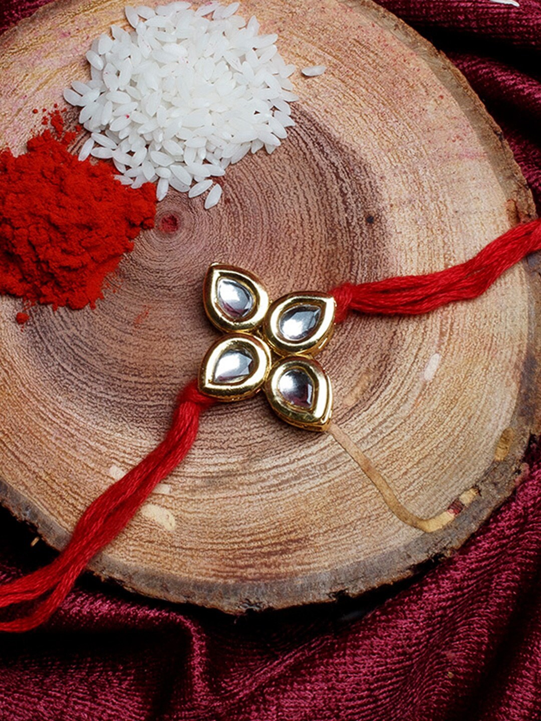 

Shoshaa Gold-Toned & Red Kundan Studded Bhai Rakhi