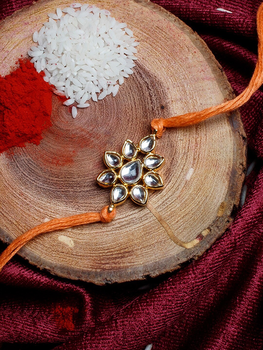 

Shoshaa Gold-Toned & Orange Kundan Studded Bhai Rakhi