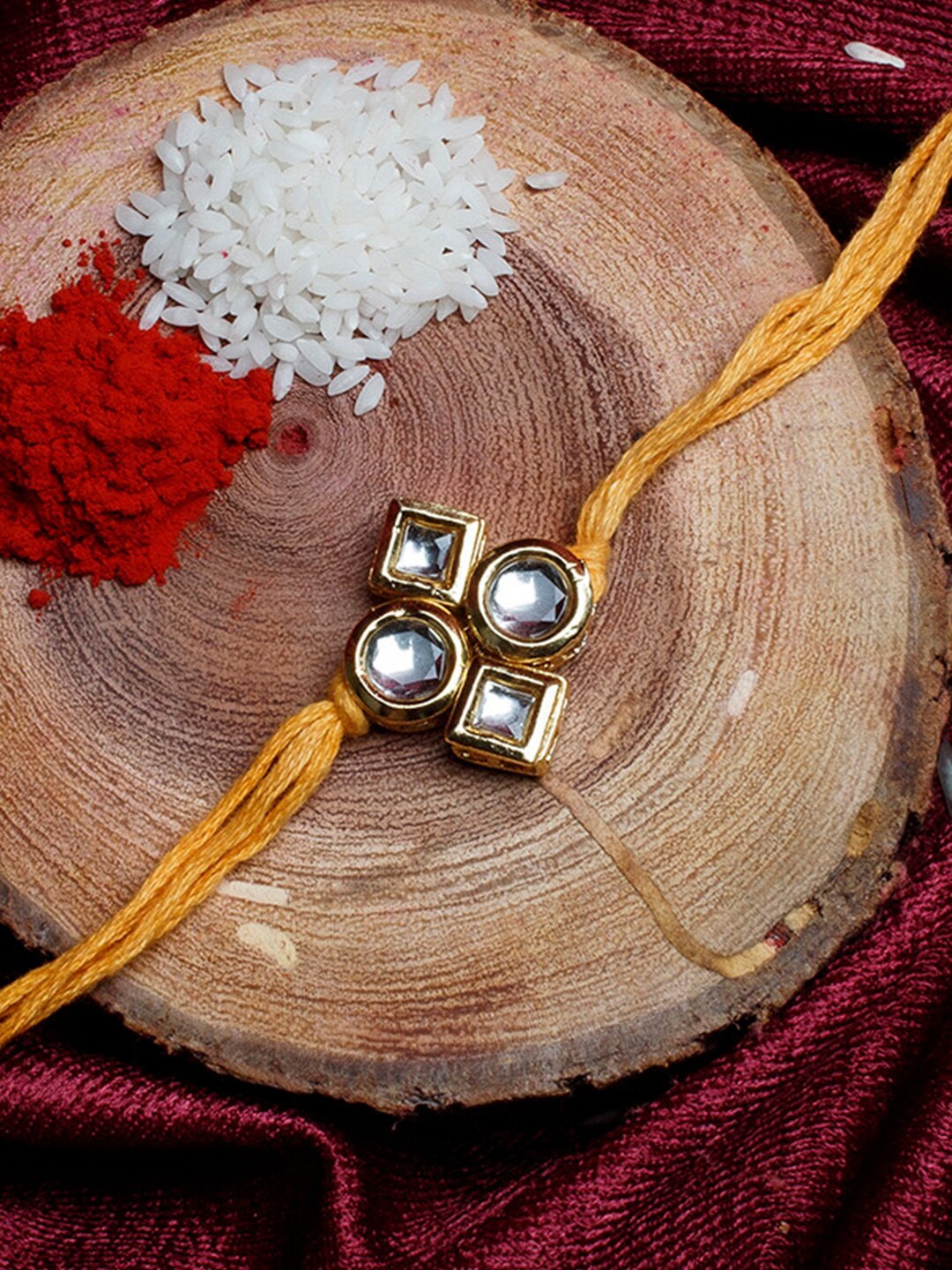 

Shoshaa Gold-Plated Handcrafted Kundan Yellow Thread Single Bhai Rakhi