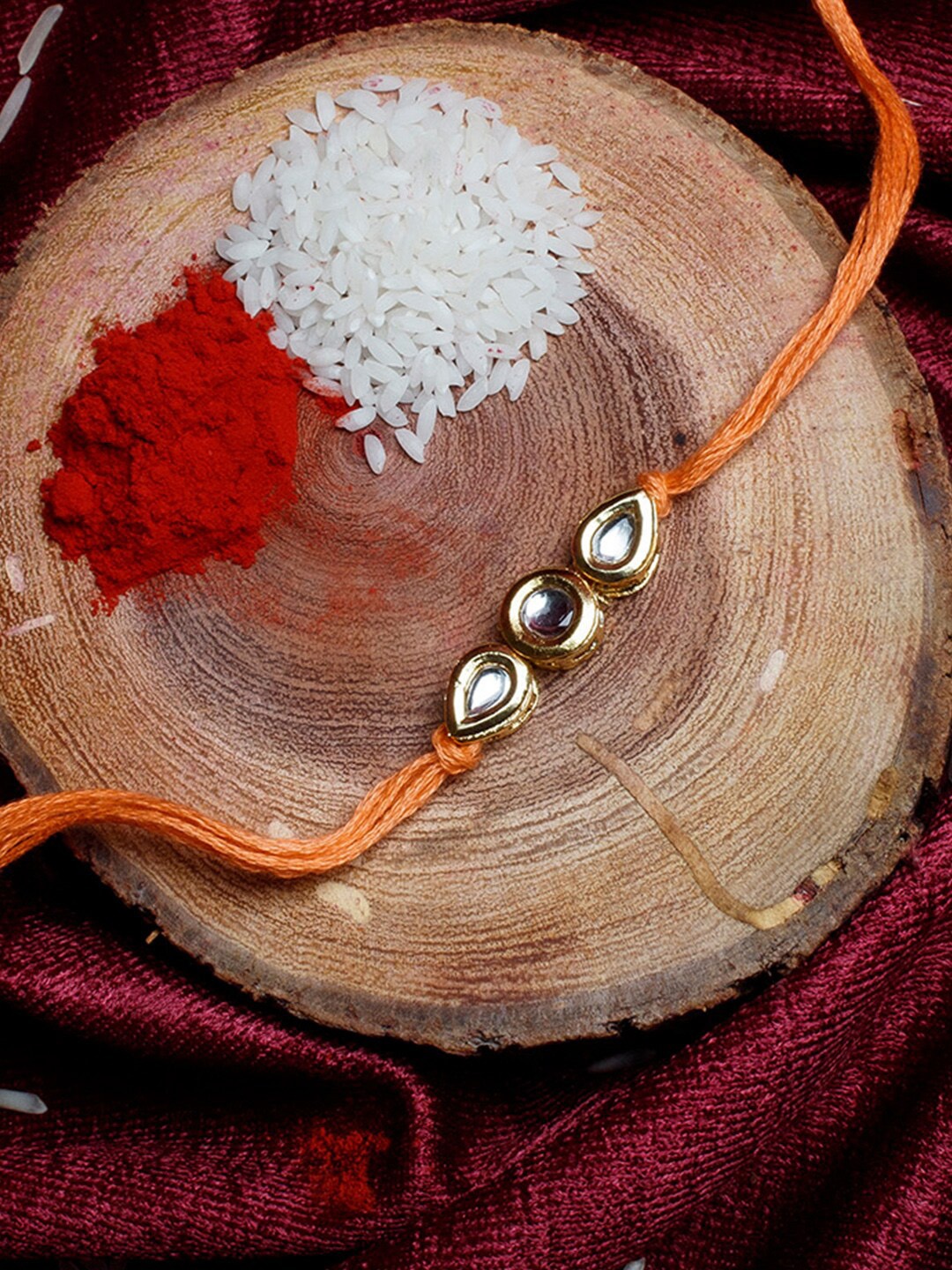 

Shoshaa Gold-Toned & Orange Kundan Studded Bhai Rakhi