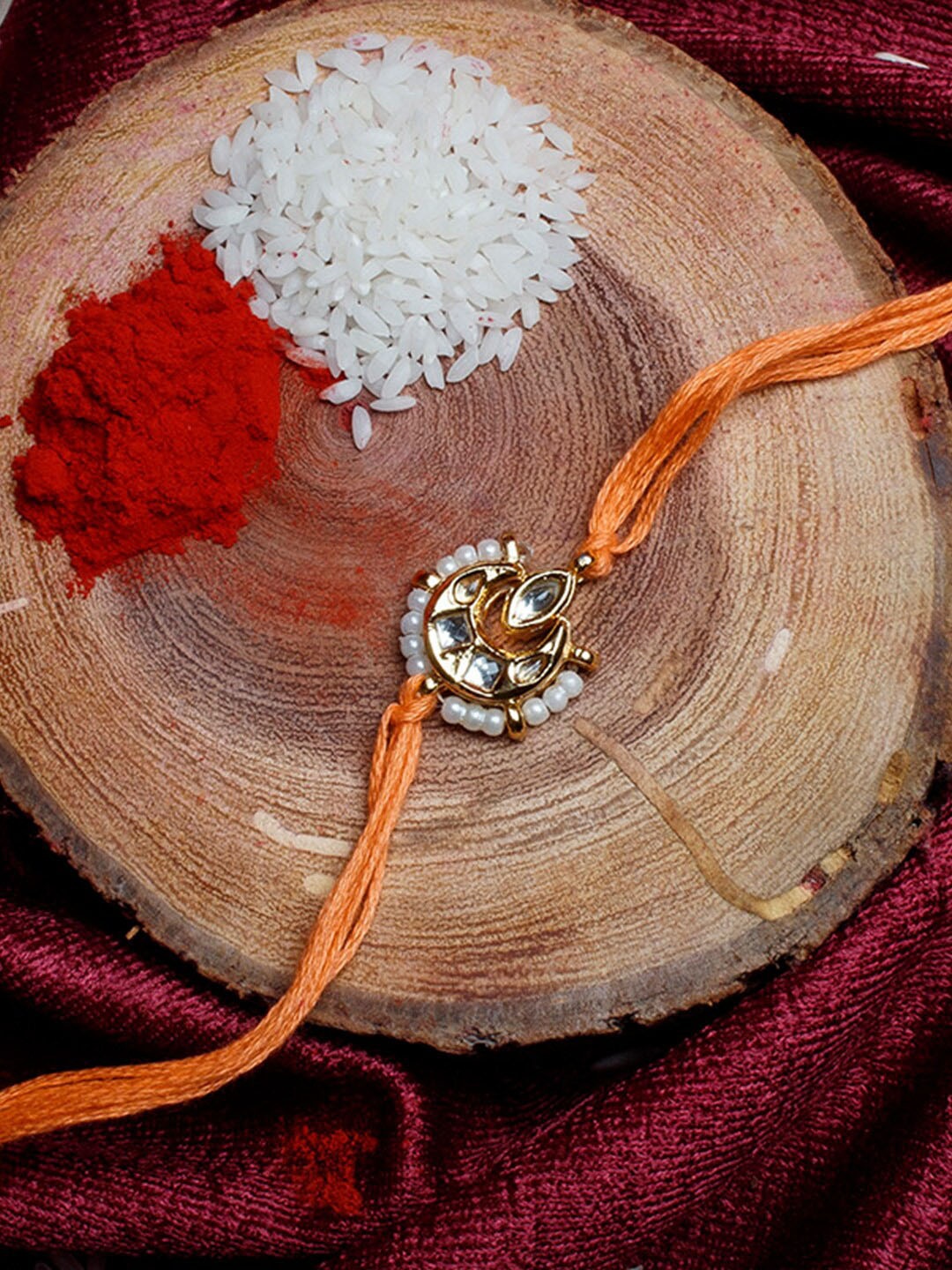 

Shoshaa Gold-Plated Handcrafted Kundan & Beaded Orange Thread Single Bhai Rakhi
