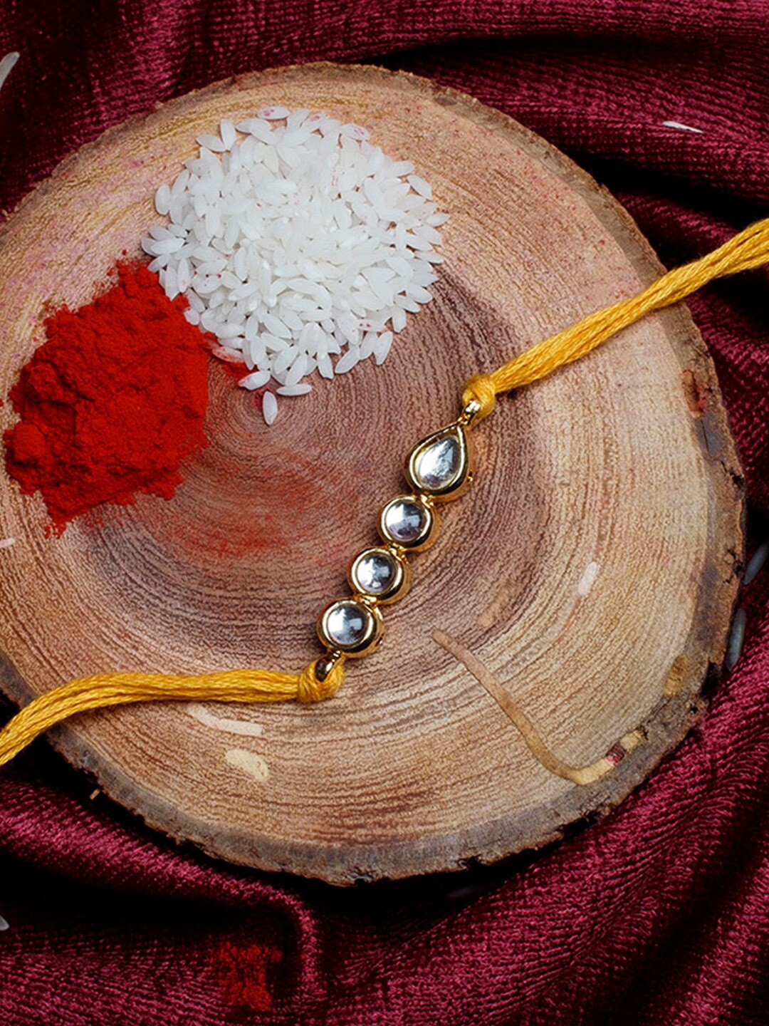 

Shoshaa Gold-Plated Handcrafted Kundan Yellow Thread Single Bhai Rakhi