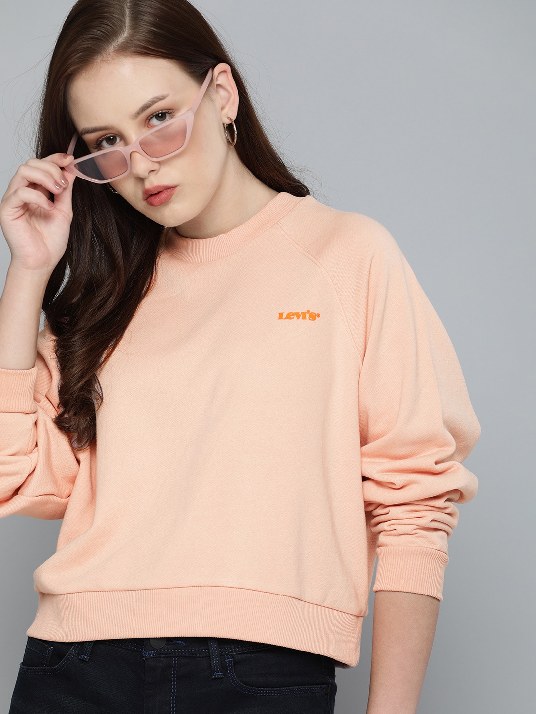 

Levis Women Peach Pink Solid Round-Neck Crop Pullover Sweatshirt With Logo Print