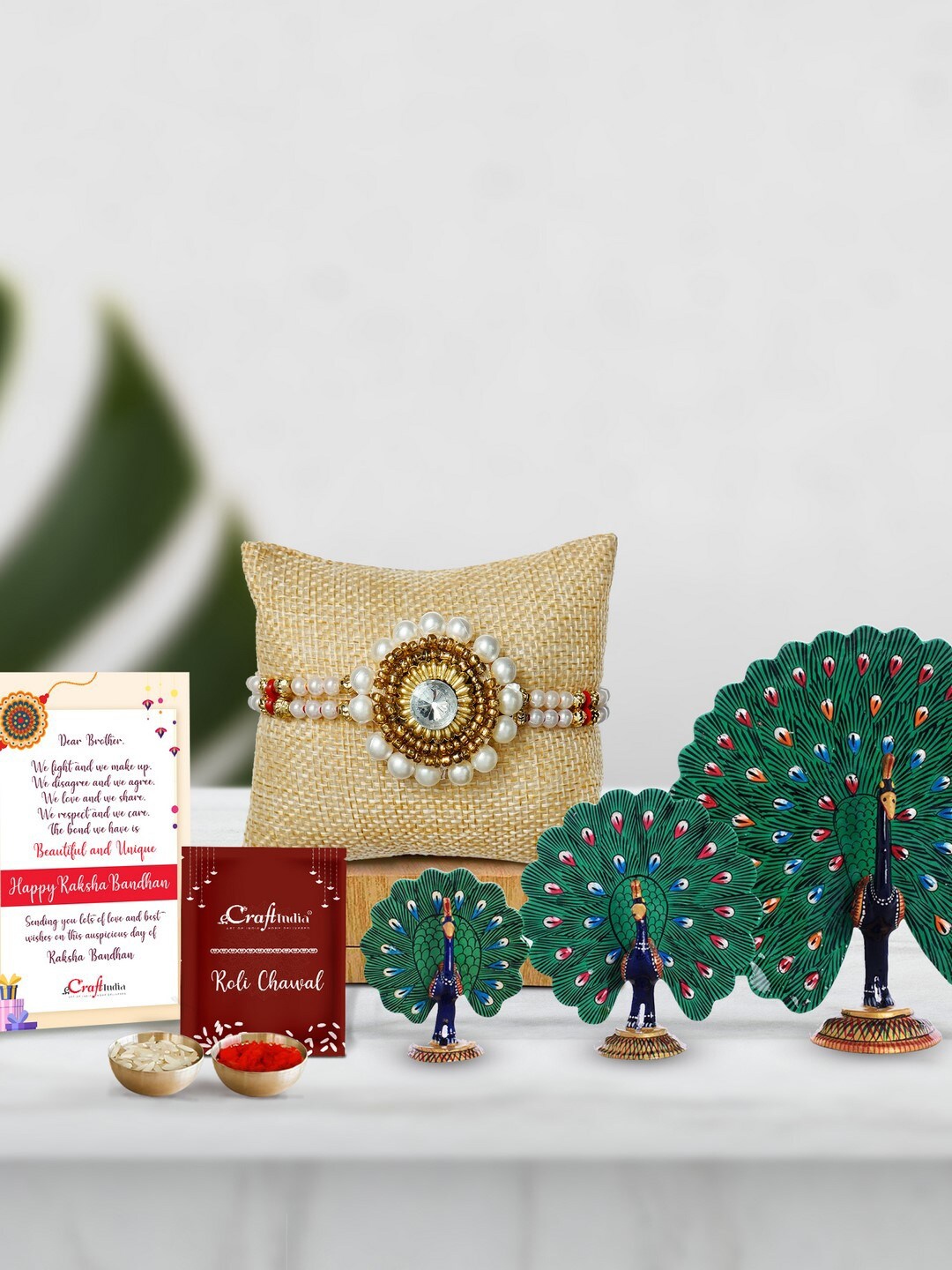 

eCraftIndia Stone Pearl Rakhi With Set of 3 Meenakari Dancing Peacocks Figurine & Card, Gold