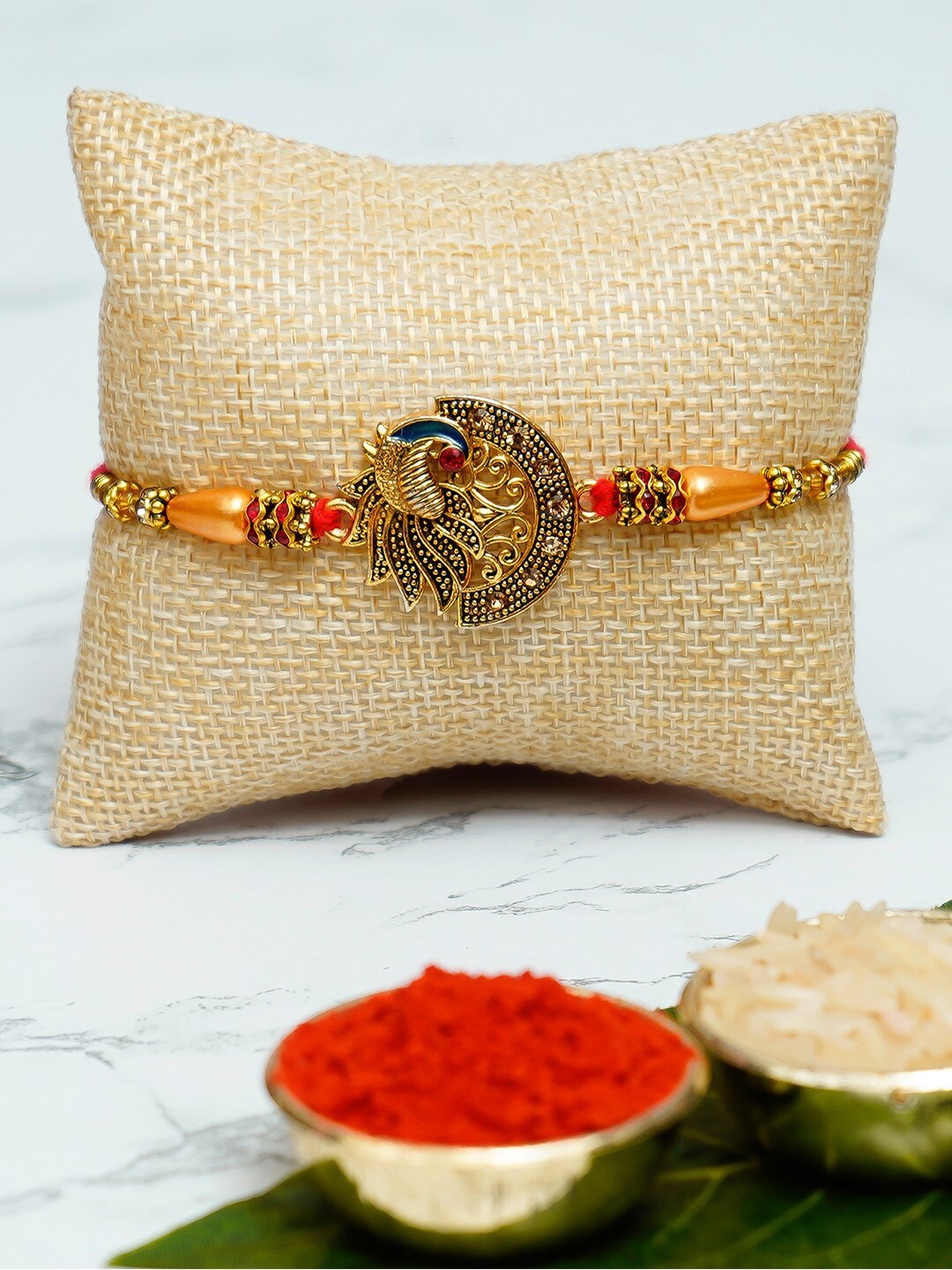 

eCraftIndia Peocock Rakhi With Decorative Brass Elephant Fingurine And Roli Chawal, Card, Gold