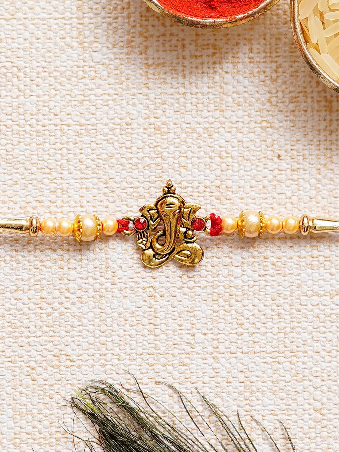 

eCraftIndia Gold-Toned & Red Designer Ganesha Rakhi & Roli Chawal Pack