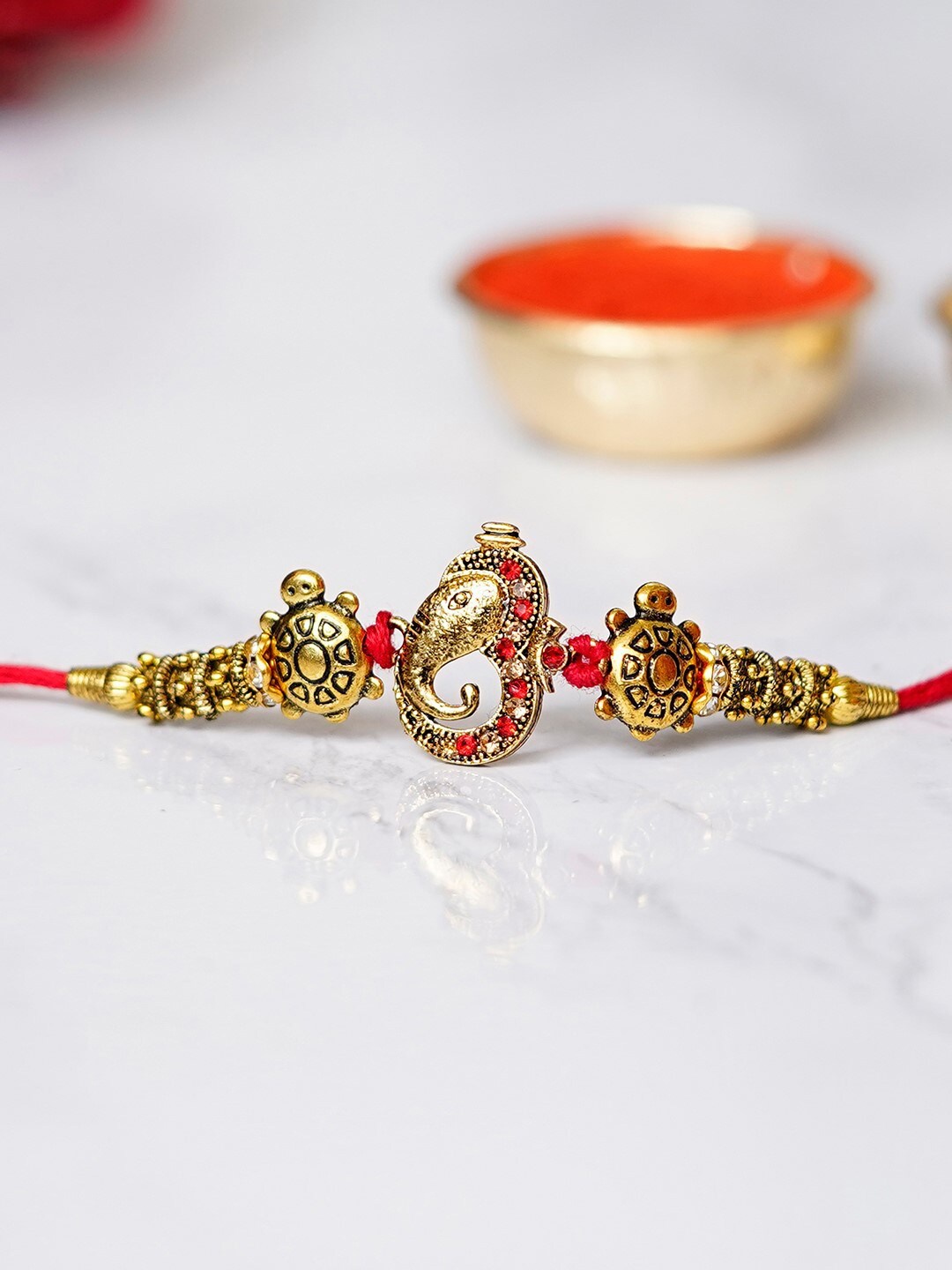 

eCraftIndia Gold-Toned & Red Studded Ganesha Rakhi