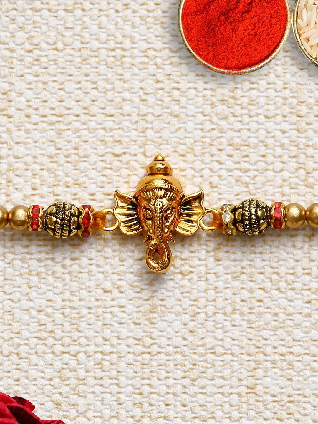 

eCraftIndia Gold-Toned & Red Ganesha Rakhi