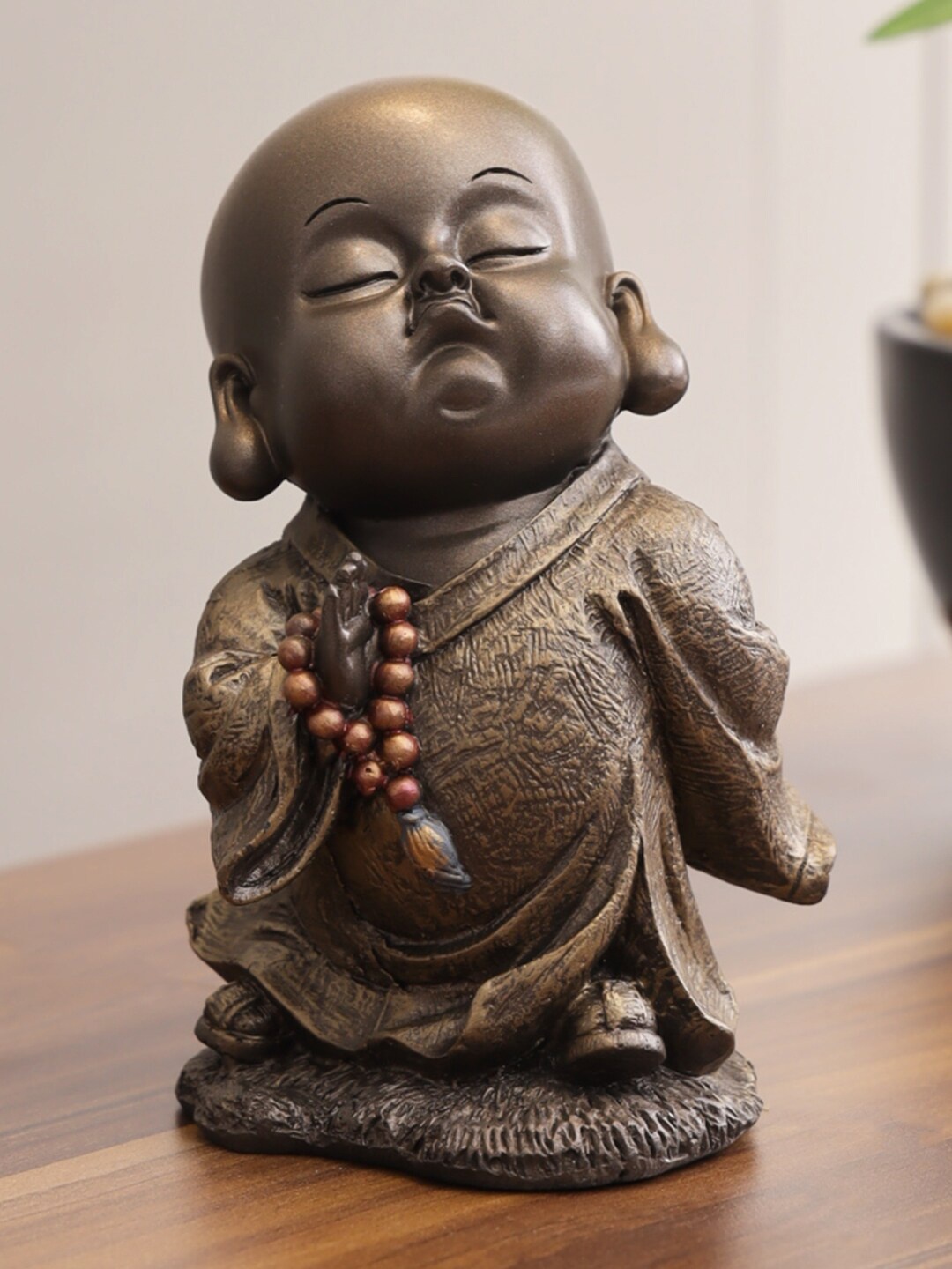 

HomeTown Brown & Bronze-Toned Naqsh Polyresin Attitude Monk Mala In Right Figurine Showpiece
