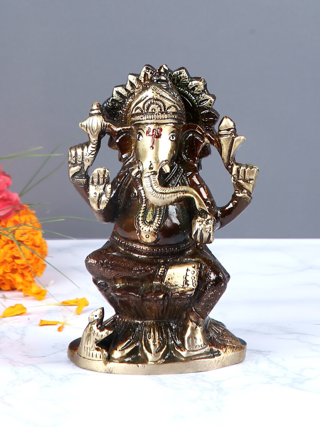 

Aapno Rajasthan Brown & Gold-Toned Brass Lord Ganesha Statue with Oxidised Finish Showpiece
