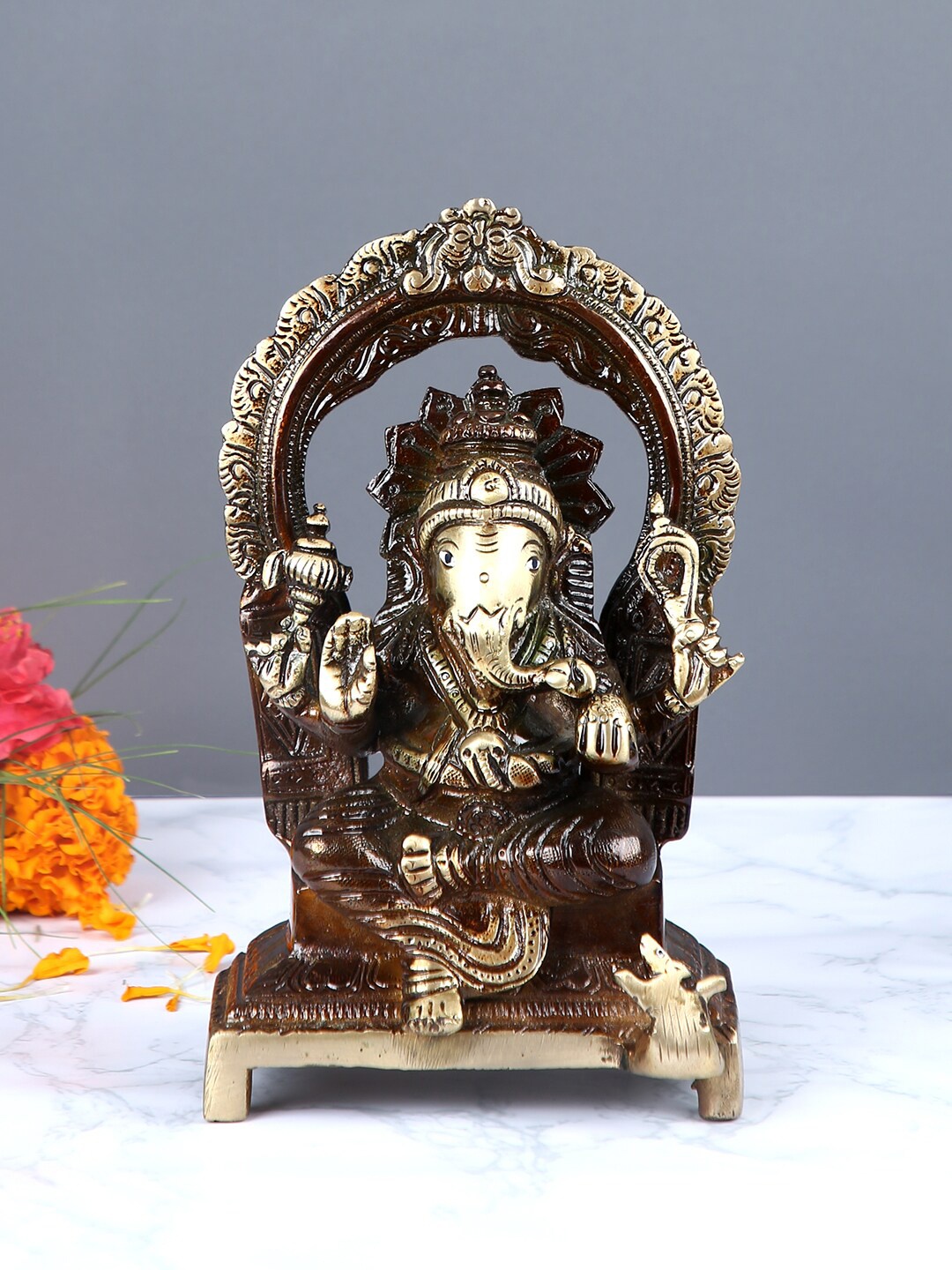 

Aapno Rajasthan Brown & Gold-Toned Lord Ganesha on Throne Brass Statue Showpiece