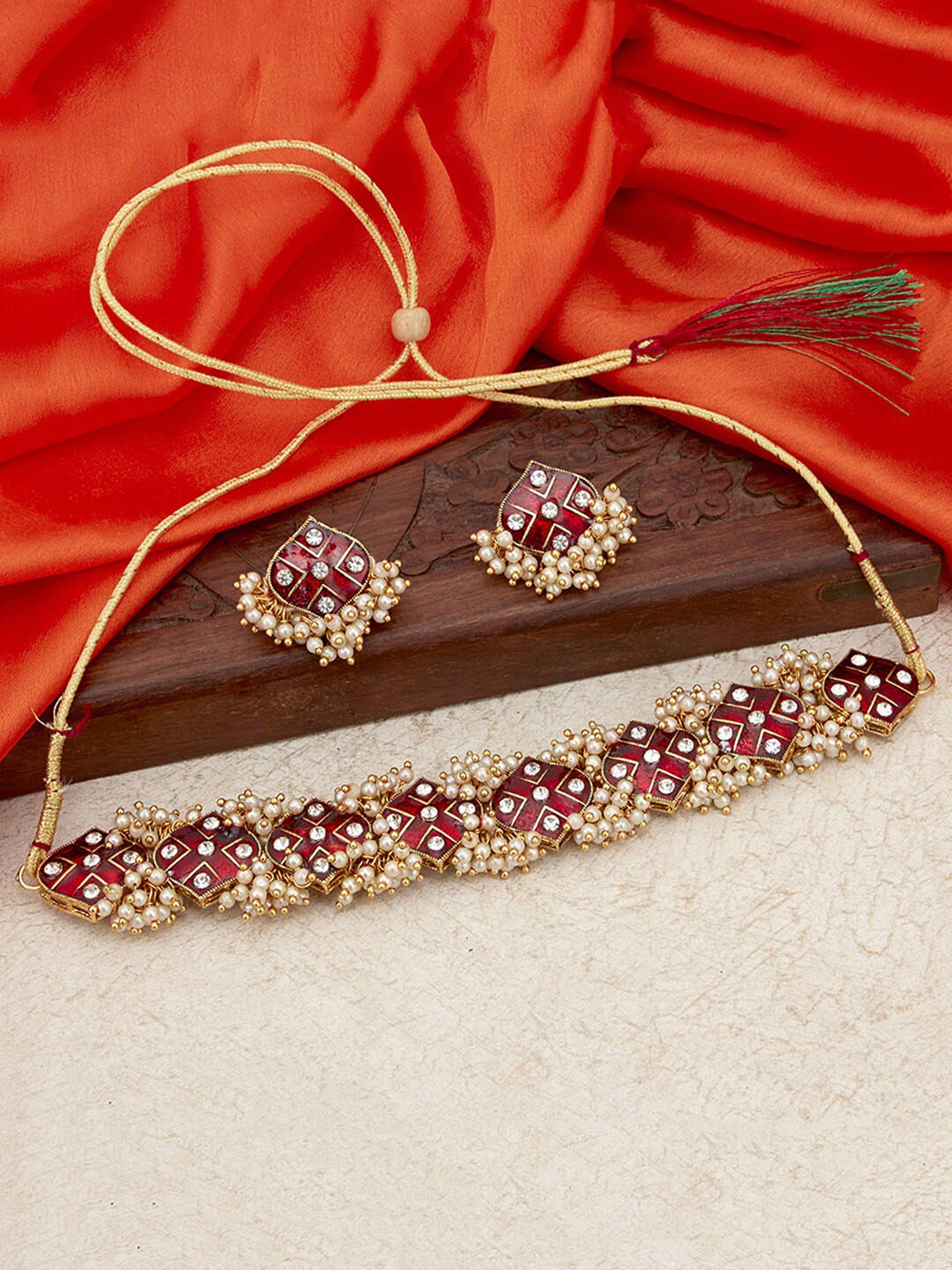 

Sukkhi Gold-Plated White & Red Stone-Studded & Pearl Beaded Meenakari Jewellery Set