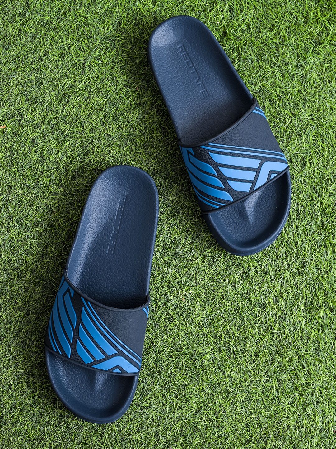 

Red Tape Men Navy Blue Printed Rubber Sliders