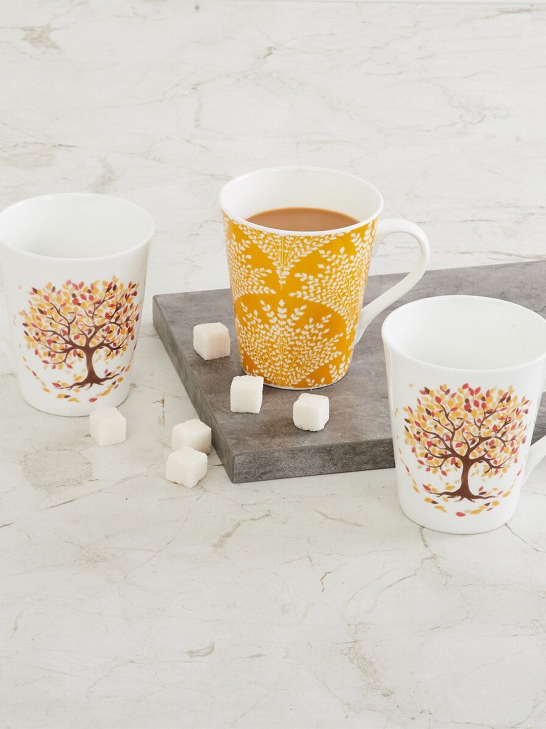 

Home Centre White & Yellow 3 Pieces Printed Bone China Glossy Mugs