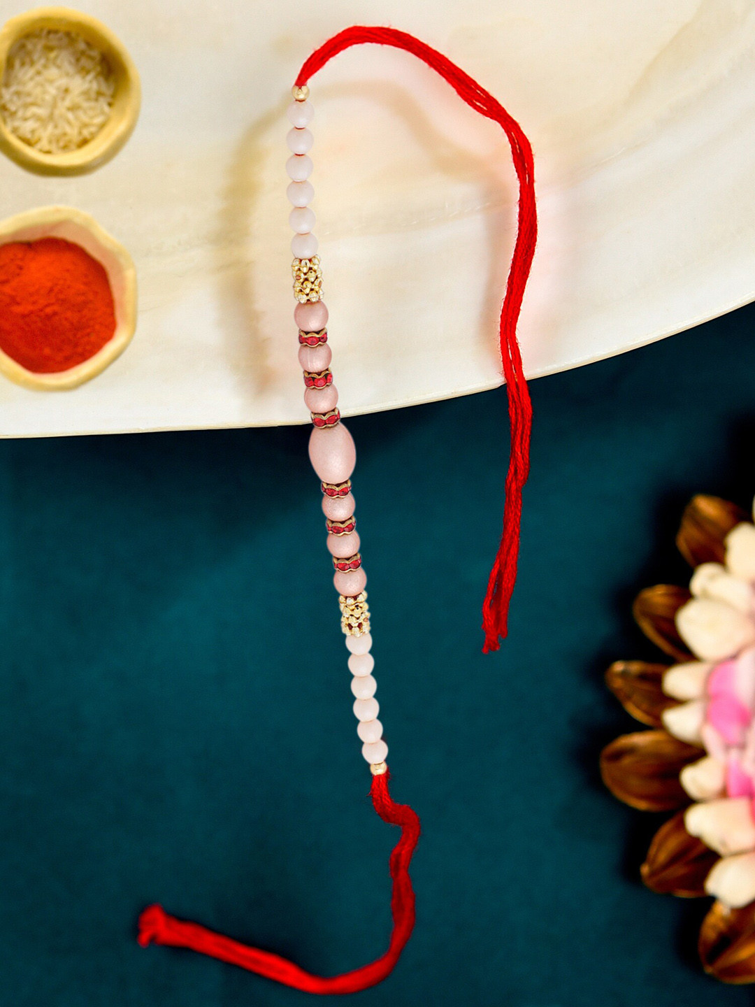 

Zaveri Pearls Gold-Toned Beads Embellished Rakhi With Chawal Roli Pack