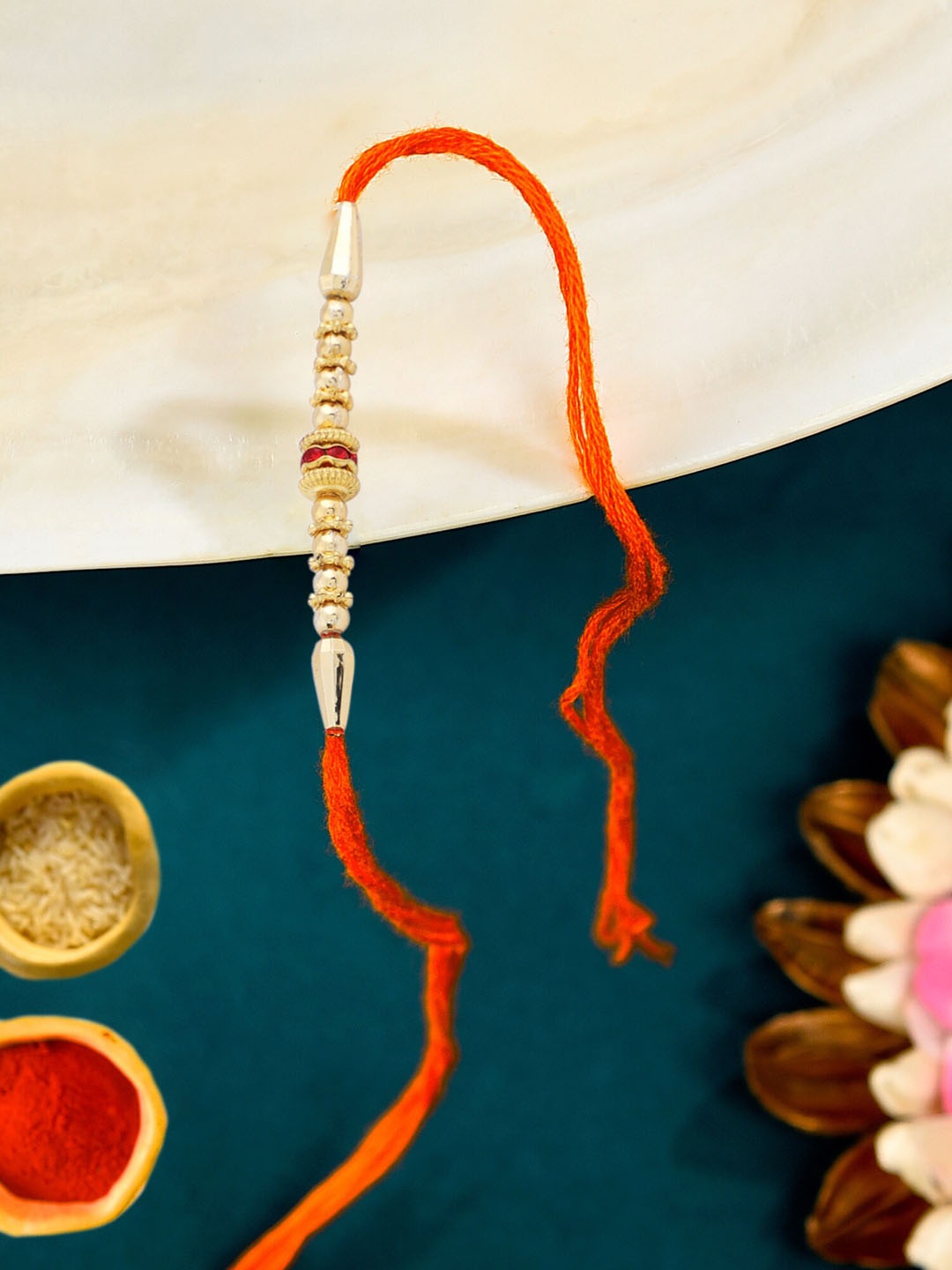 

Zaveri Pearls Gold -Tone Beads Embellished Rakhi With Chawal Roli Pack