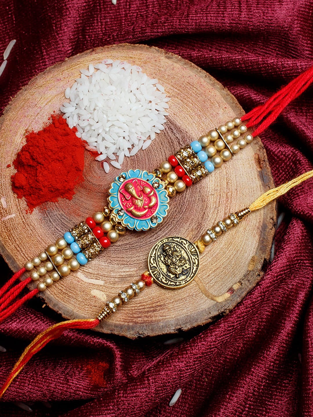 

Shoshaa Set Of 2 Red Stone & Beaded Ganesh Ji Religious Combo Bhai Rakhi, Gold